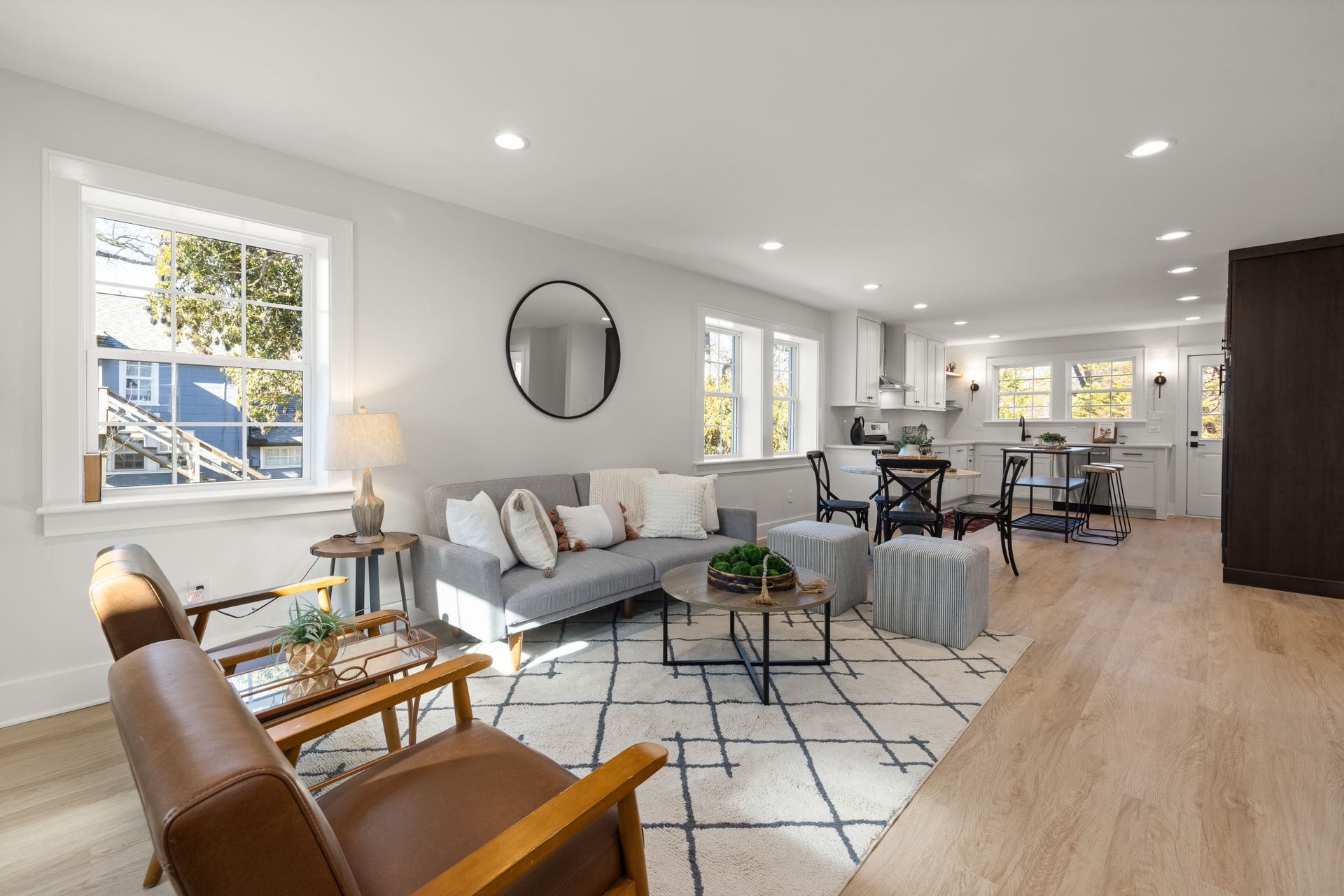 Sunlit living room with a sofa and freshly arranged furnishings
